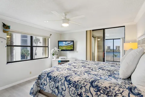 a bedroom with a large bed and a flat screen tv