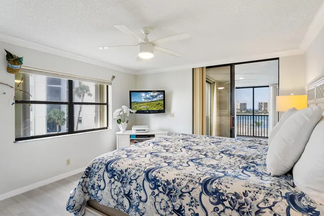 a bedroom with a large bed and a flat screen tv