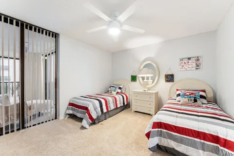 a bedroom with two beds and painting on the wall