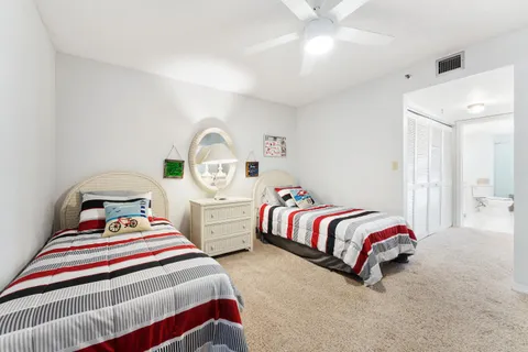 a bedroom with two beds and window