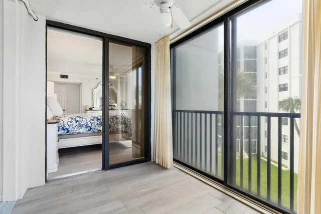 a view of a bedroom with wooden floor