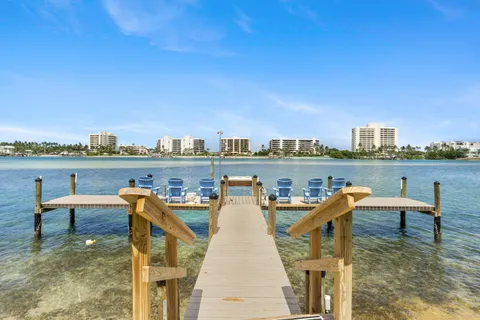 a view of a lake with outdoor seating and city view
