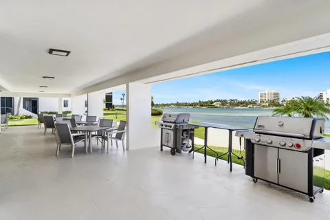 a living room with furniture a flat screen tv and a kitchen view