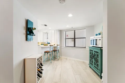 a dining room with furniture and a window