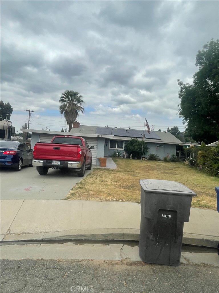 5257 Monterey Road Riverside, CA 92506 - Photo 1 of 1 a view of a swimming pool with a lawn chairs and a fire pit