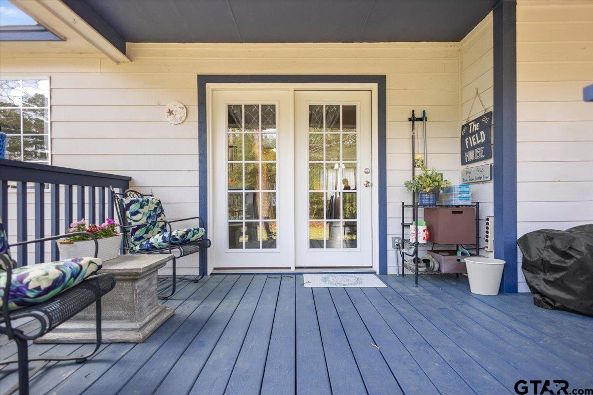 289 Acapulco Road Jefferson, TX 75657 - Photo 20 of 30 a balcony with wooden floor and furniture