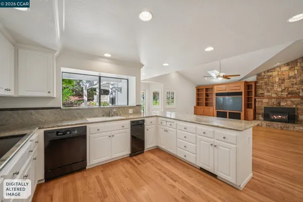 a view of kitchen with cabinets and wooden floor