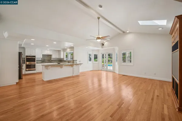 a spacious bedroom with a large bed and a large window