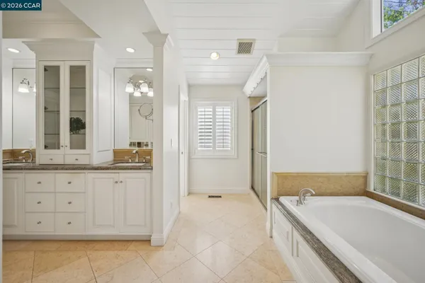 a view of a kitchen with white cabinets
