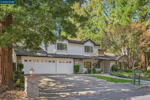 a view of a hallway with wooden floor and a livingroom