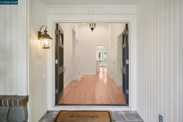 a living room with furniture fireplace and a large window