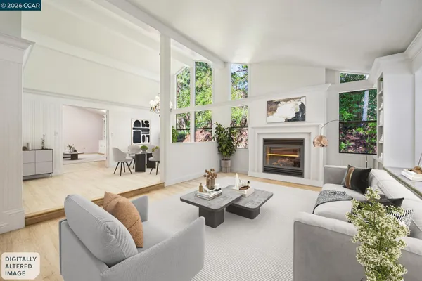 an empty room with windows and fireplace