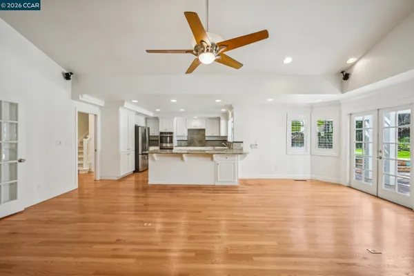 a kitchen with a dining table chairs and refrigerator
