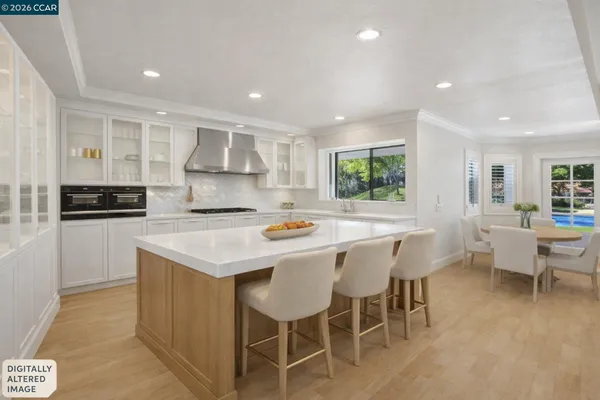 a kitchen with stainless steel appliances granite countertop a sink refrigerator and cabinets