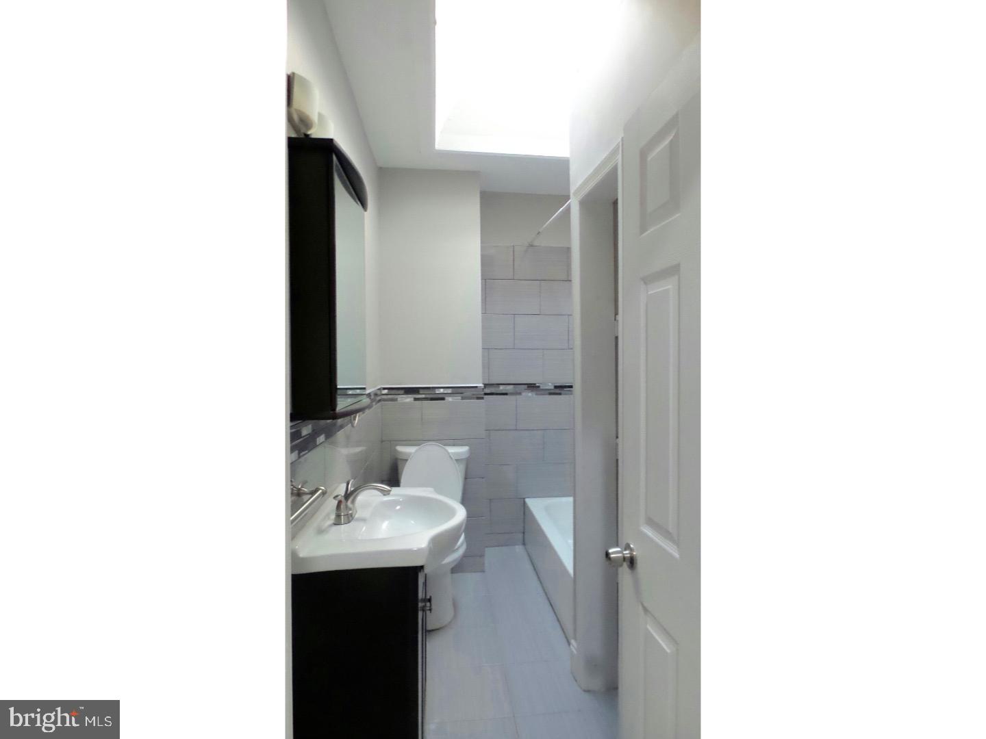 1640 South 28th Street Philadelphia, PA 19145 - Photo 14 of 24 a bathroom with a sink and a mirror