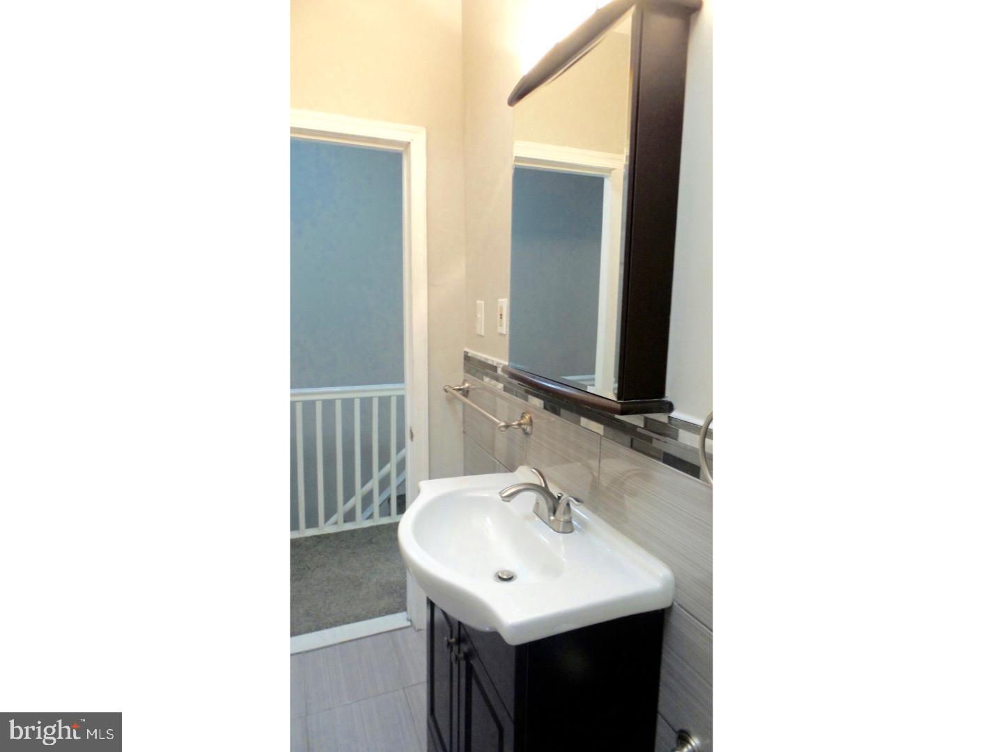 1640 South 28th Street Philadelphia, PA 19145 - Photo 15 of 24 a bathroom with a sink and a mirror