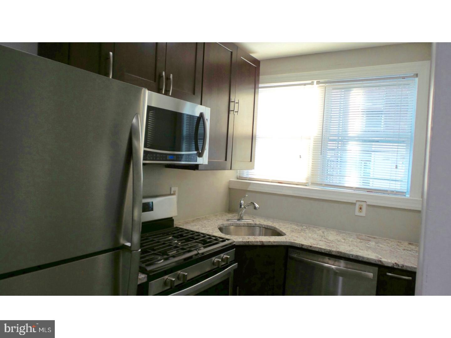 1640 South 28th Street Philadelphia, PA 19145 - Photo 9 of 24 a kitchen with a sink a window and cabinets