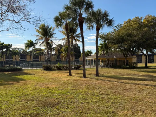 a swimming pool with outdoor seating and yard