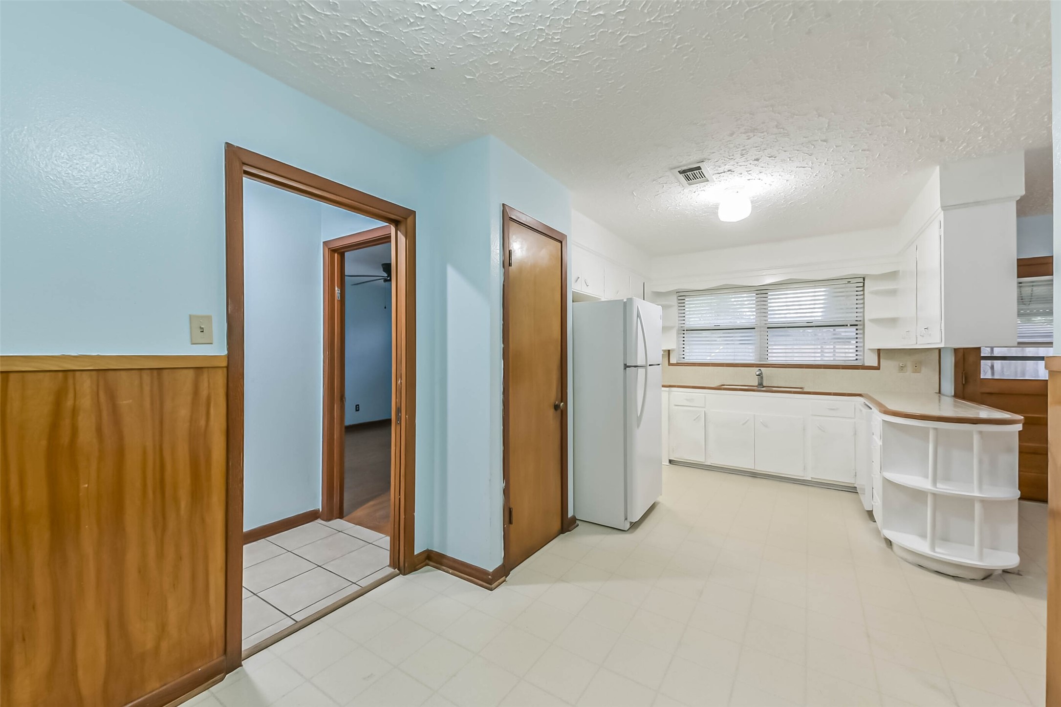 705 Dunwick Lane Pasadena, TX 77502 - Photo 15 of 27 a kitchen with white cabinets and refrigerator