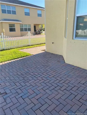 a view of a house with backyard and a barbeque