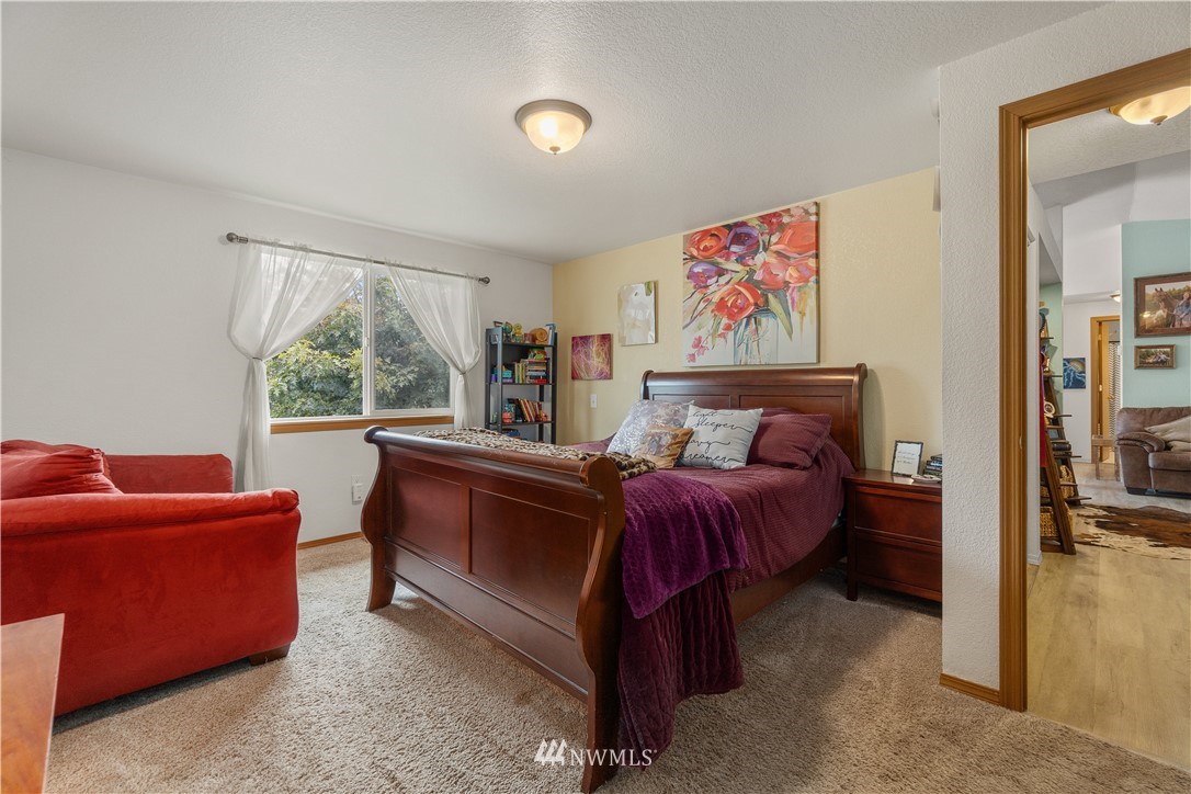 18830 Ivan Street Southwest Rochester, WA 98579 - Photo 14 of 32 a bed room with a bed and a couch