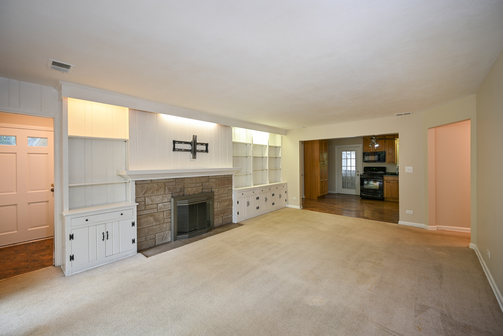 611 Saddle Road Wheaton, IL 60187 - Photo 3 of 21 a view of an empty room with a fireplace and a window