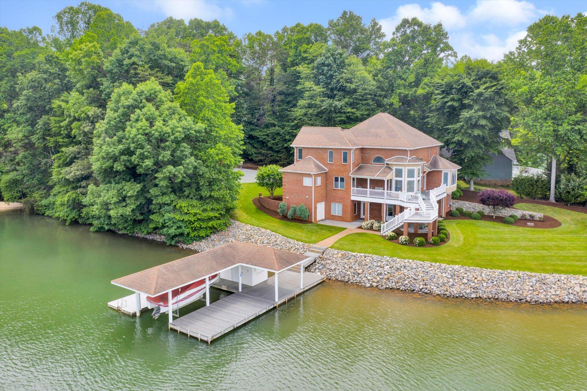 910 Somerset Cove Road Union Hall, VA 24176 - Photo 4 of 84 an aerial view of a house with a garden and lake view