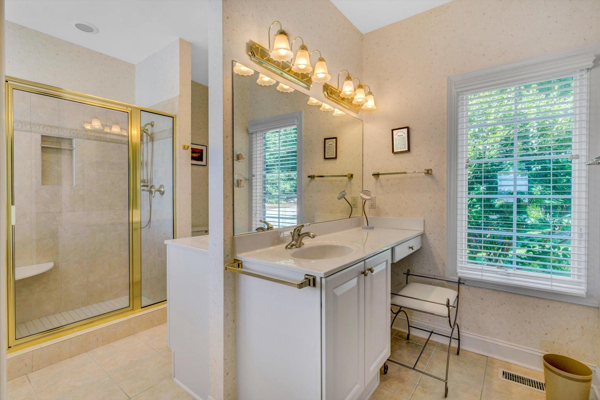 910 Somerset Cove Road Union Hall, VA 24176 - Photo 35 of 84 a bathroom with a granite countertop sink a large mirror and a shower