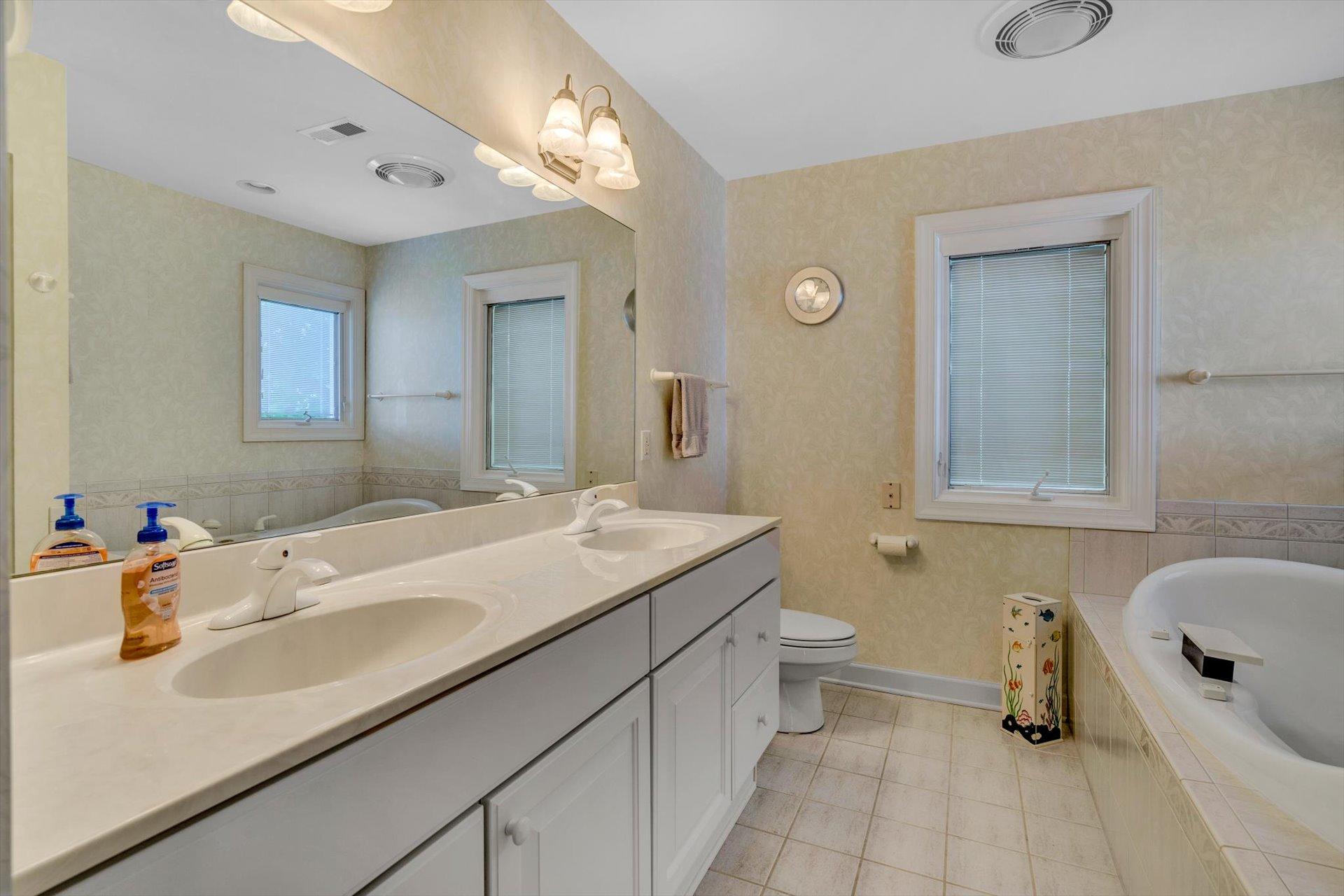 910 Somerset Cove Road Union Hall, VA 24176 - Photo 48 of 84 a bathroom with a sink double vanity granite and a toilet