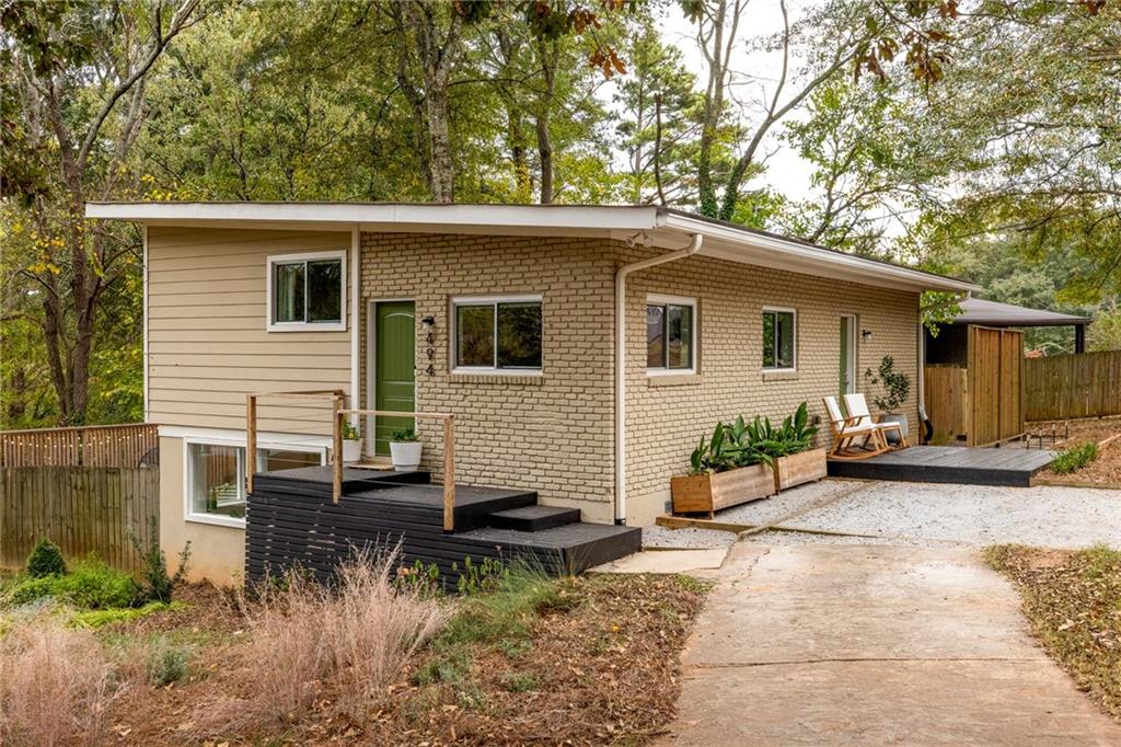 494 Rosemont Drive Southeast Decatur, GA 30032 - Photo 1 of 1 a backyard of a house with potted plants and a large tree