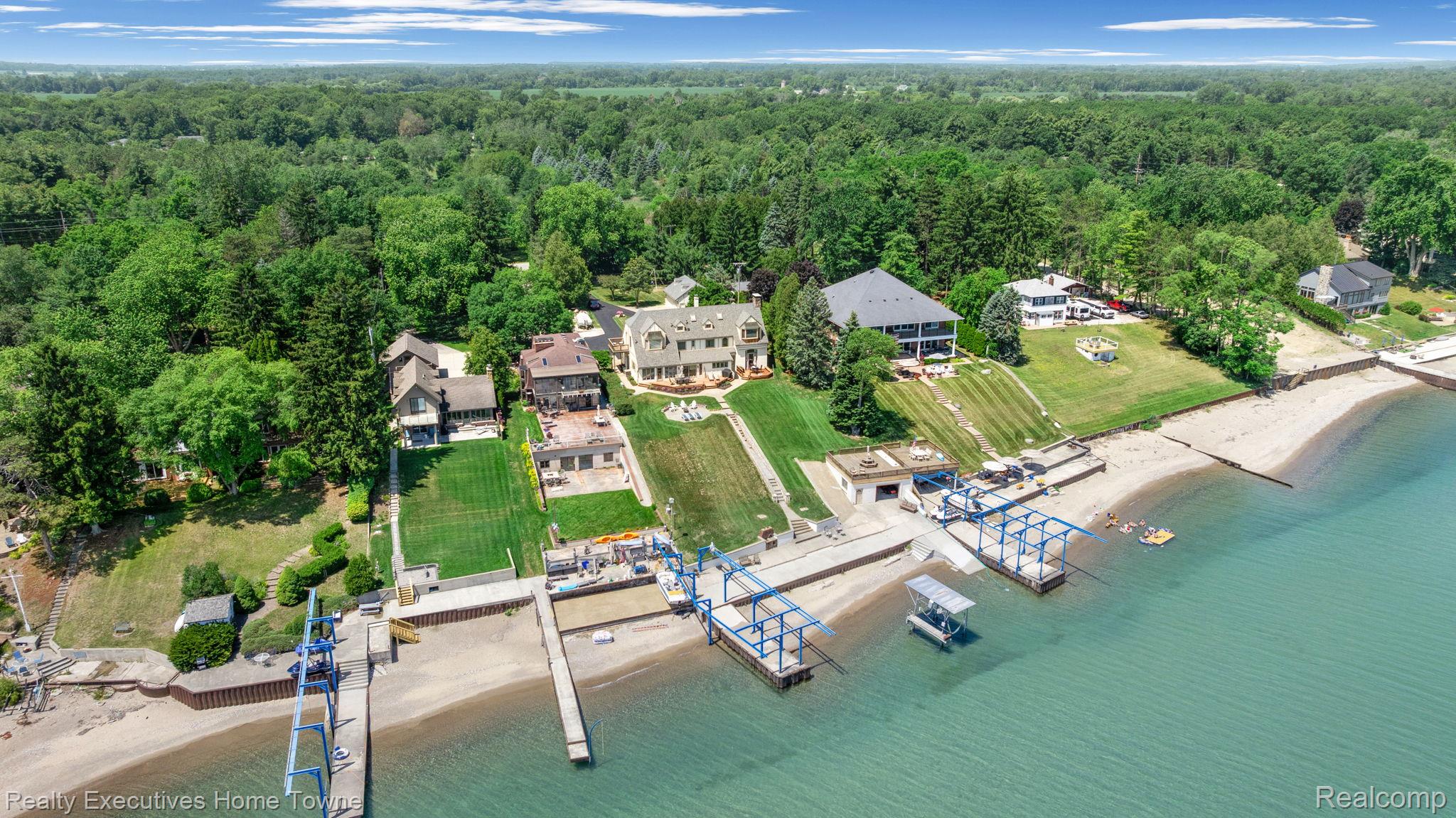 8308 Lakeshore Road Fort Gratiot, MI 48059 - Photo 19 of 79 Expansive waterfront property featuring a private sandy beach and multiple boat lifts