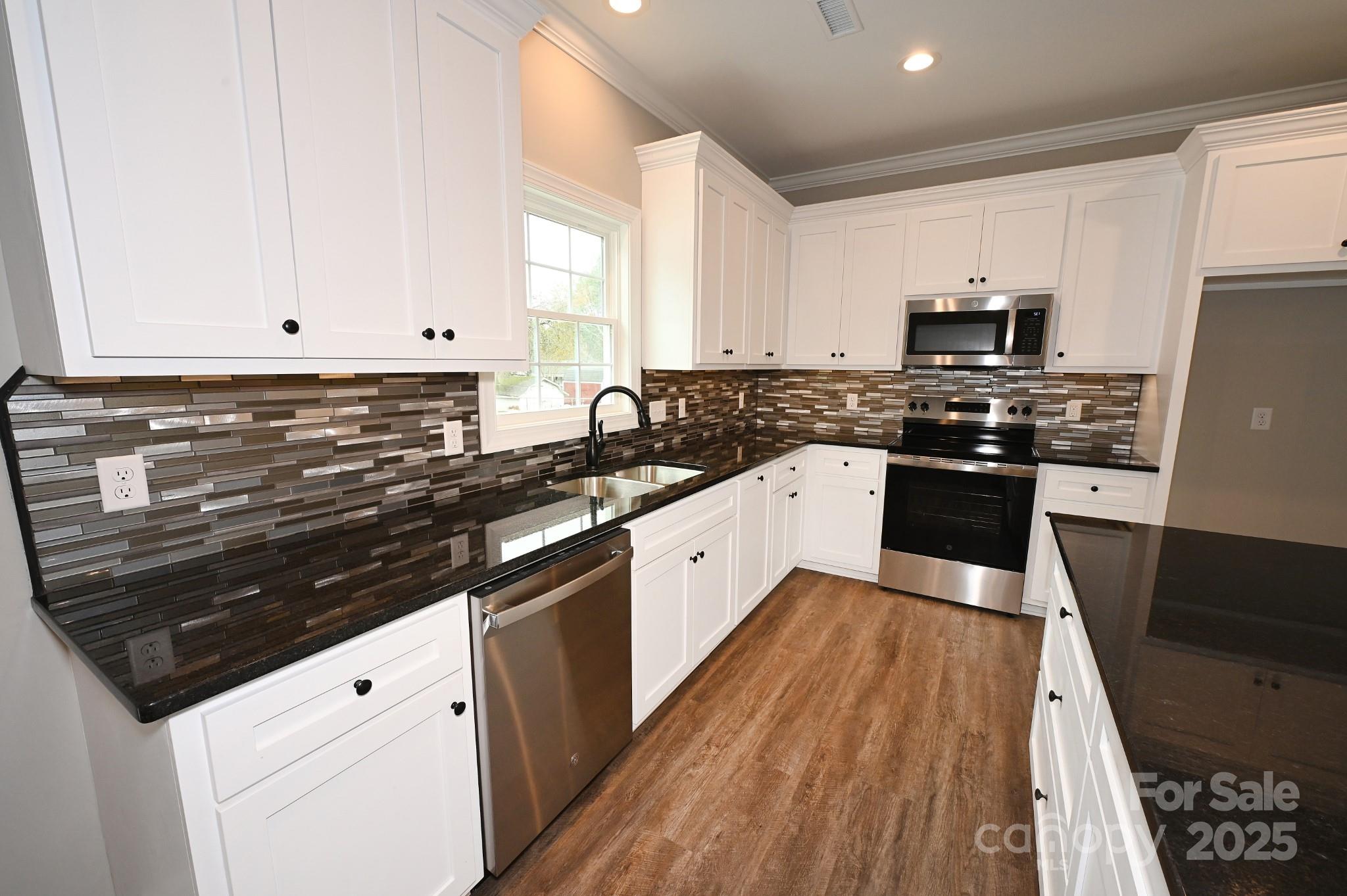 3835 Sulphur Springs Road Northeast Hickory, NC 28601 - Photo 11 of 44 a large white kitchen with stainless steel appliances granite countertop a stove a sink dishwasher and a refrigerator