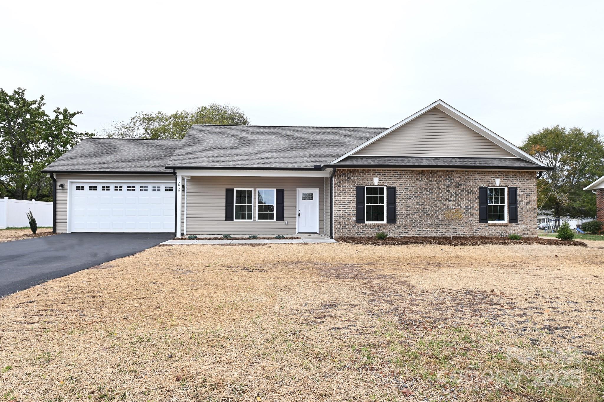 3835 Sulphur Springs Road Northeast Hickory, NC 28601 - Photo 2 of 44 a front view of a house with yard and trees