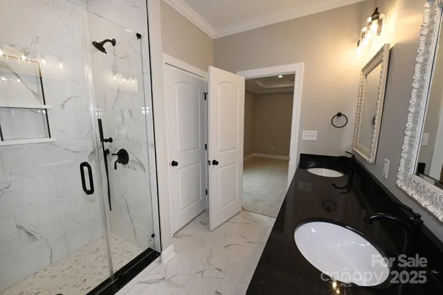a bathroom with a granite countertop sink a mirror and a shower