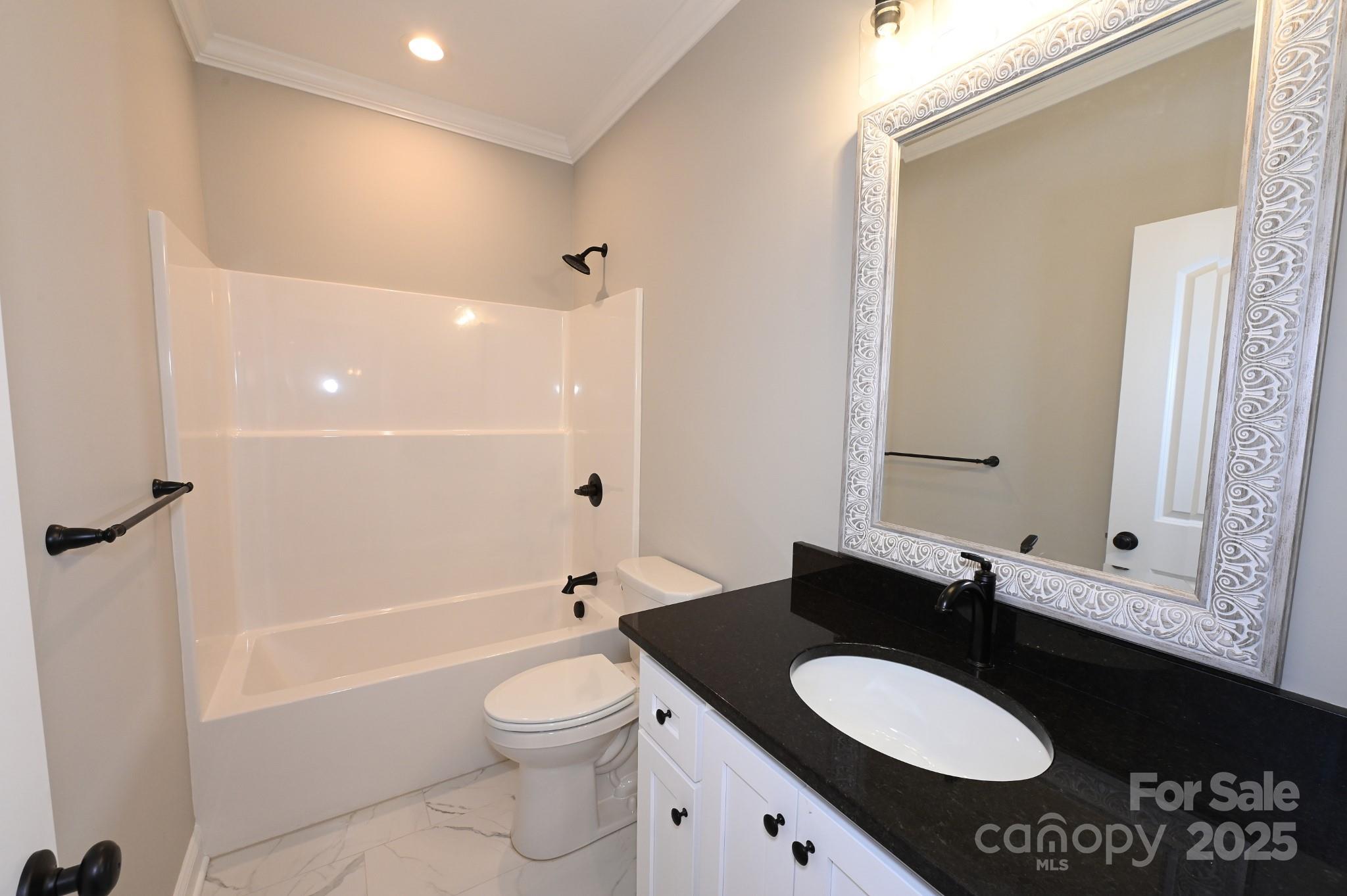 3835 Sulphur Springs Road Northeast Hickory, NC 28601 - Photo 40 of 44 a bathroom with a granite countertop sink toilet a mirror and shower