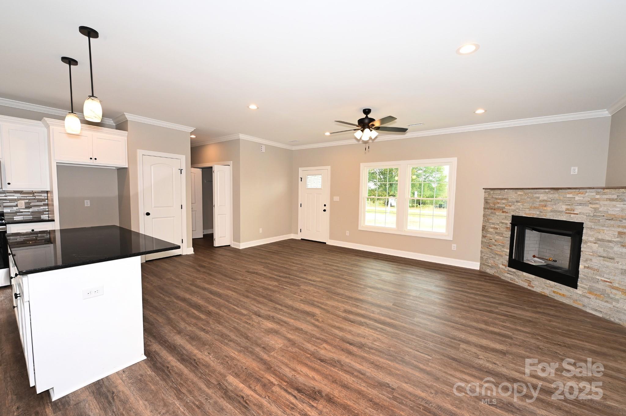 3835 Sulphur Springs Road Northeast Hickory, NC 28601 - Photo 5 of 44 a view of a kitchen with a sink wooden floor and a fireplace