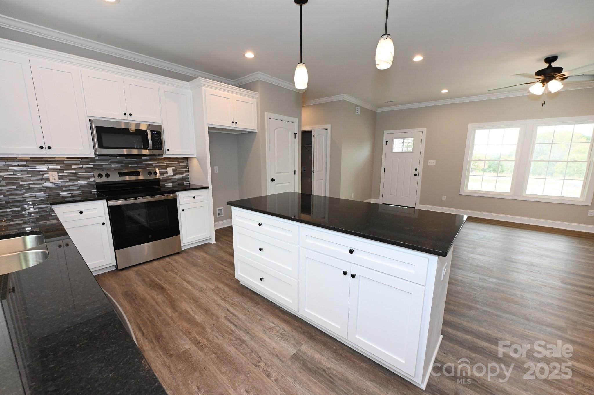 3835 Sulphur Springs Road Northeast Hickory, NC 28601 - Photo 10 of 44 a kitchen with stainless steel appliances kitchen island granite countertop a stove a sink and a refrigerator