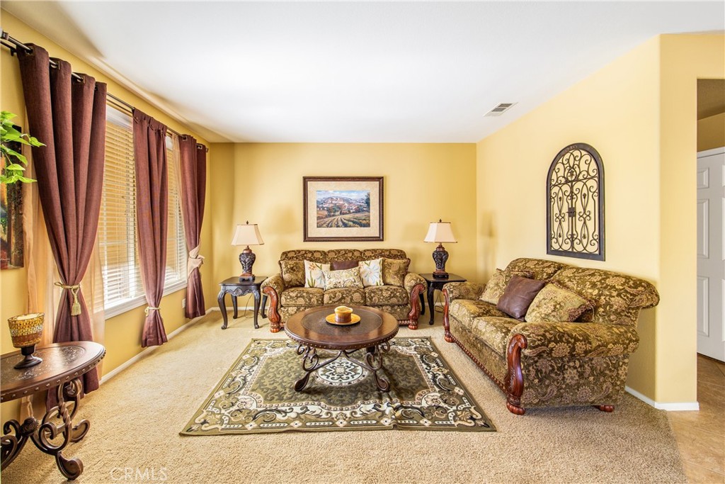 18936 Malkoha Street Perris, CA 92570 - Photo 11 of 70 a living room with furniture fireplace and a large window