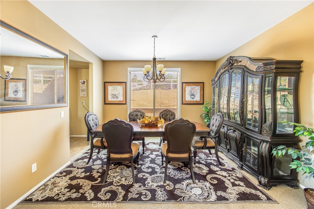 18936 Malkoha Street Perris, CA 92570 - Photo 15 of 70 a living room with furniture and a chandelier