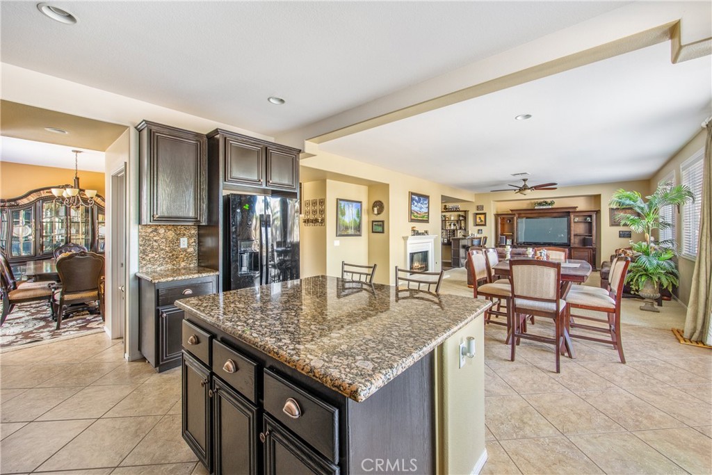 18936 Malkoha Street Perris, CA 92570 - Photo 19 of 70 a kitchen with granite countertop a table and chairs in it