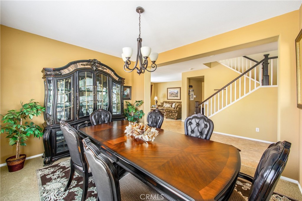 18936 Malkoha Street Perris, CA 92570 - Photo 21 of 70 a view of a dining room with furniture and a potted plant
