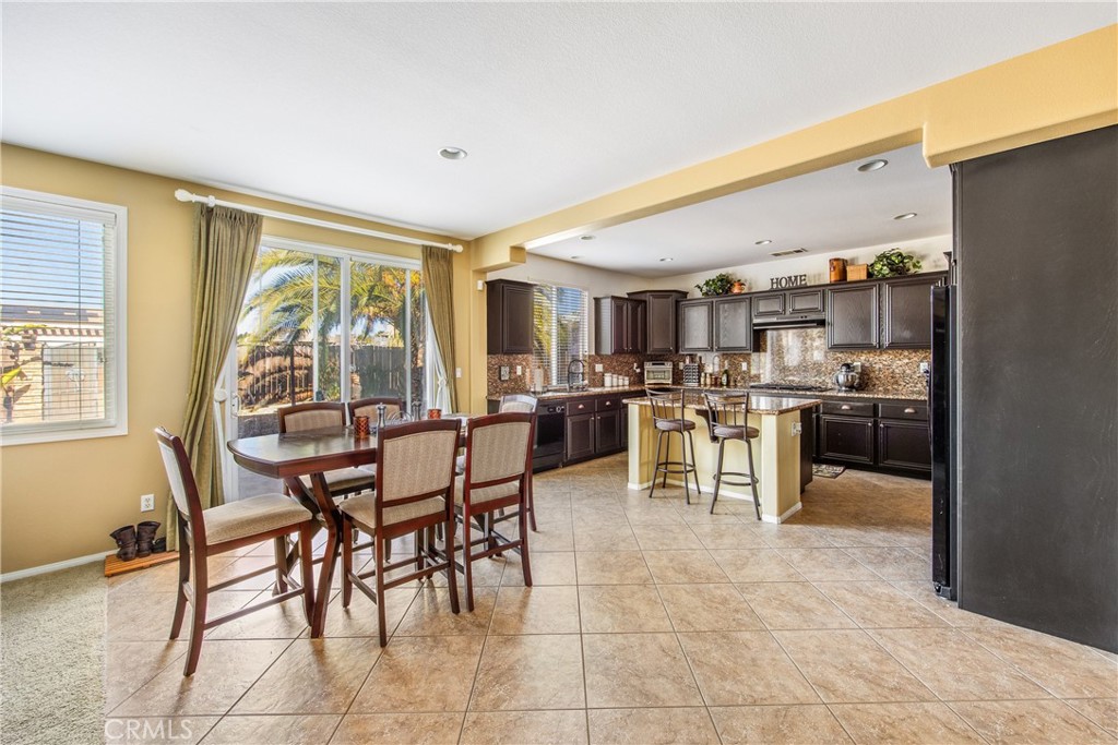 18936 Malkoha Street Perris, CA 92570 - Photo 22 of 70 a kitchen with a table and chairs in it