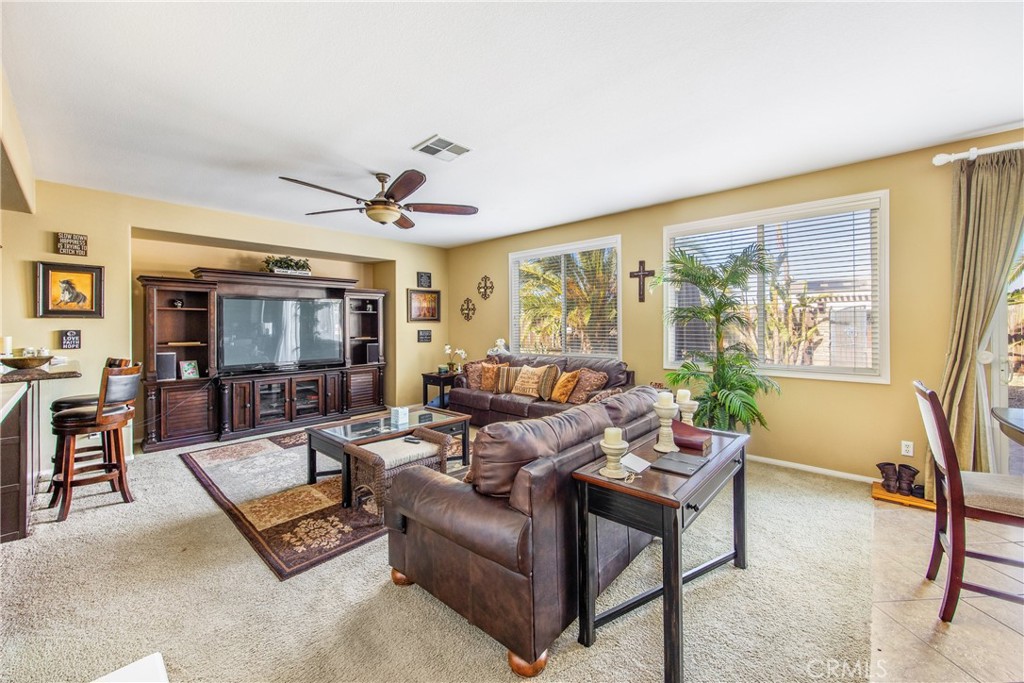 18936 Malkoha Street Perris, CA 92570 - Photo 23 of 70 a living room with furniture and large windows
