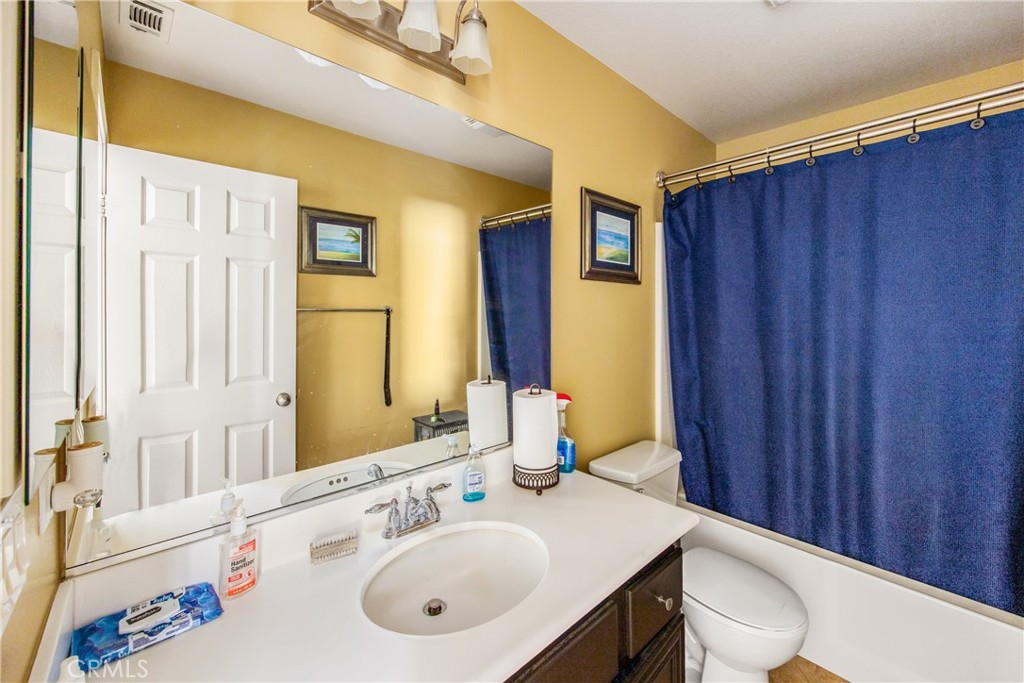 18936 Malkoha Street Perris, CA 92570 - Photo 28 of 70 a bathroom with a sink vanity mirror and toilet
