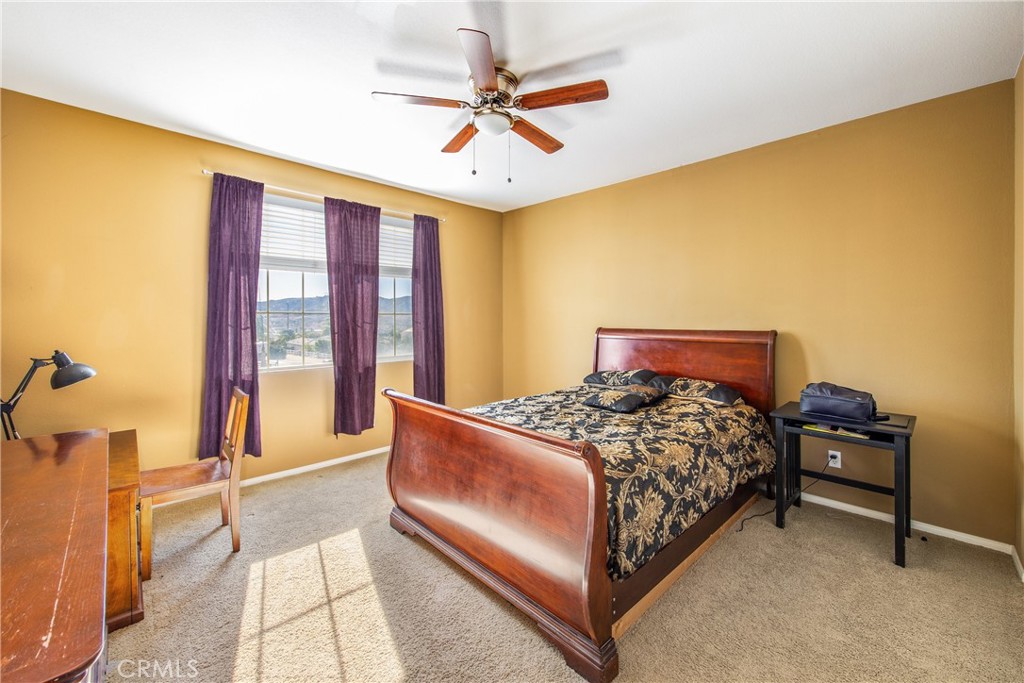 18936 Malkoha Street Perris, CA 92570 - Photo 36 of 70 a bedroom with a bed and a table