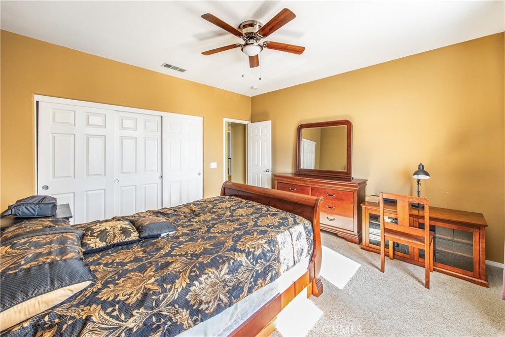 18936 Malkoha Street Perris, CA 92570 - Photo 37 of 70 a bedroom with a bed and a chandelier