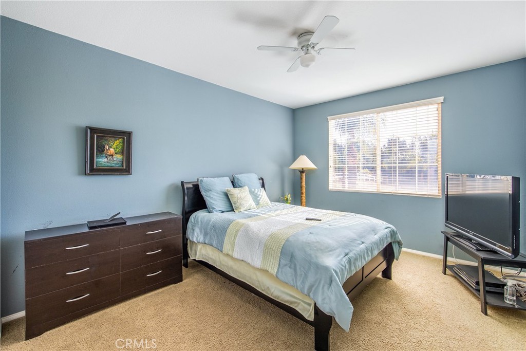 18936 Malkoha Street Perris, CA 92570 - Photo 40 of 70 a bedroom with a bed and a tv on the dresser
