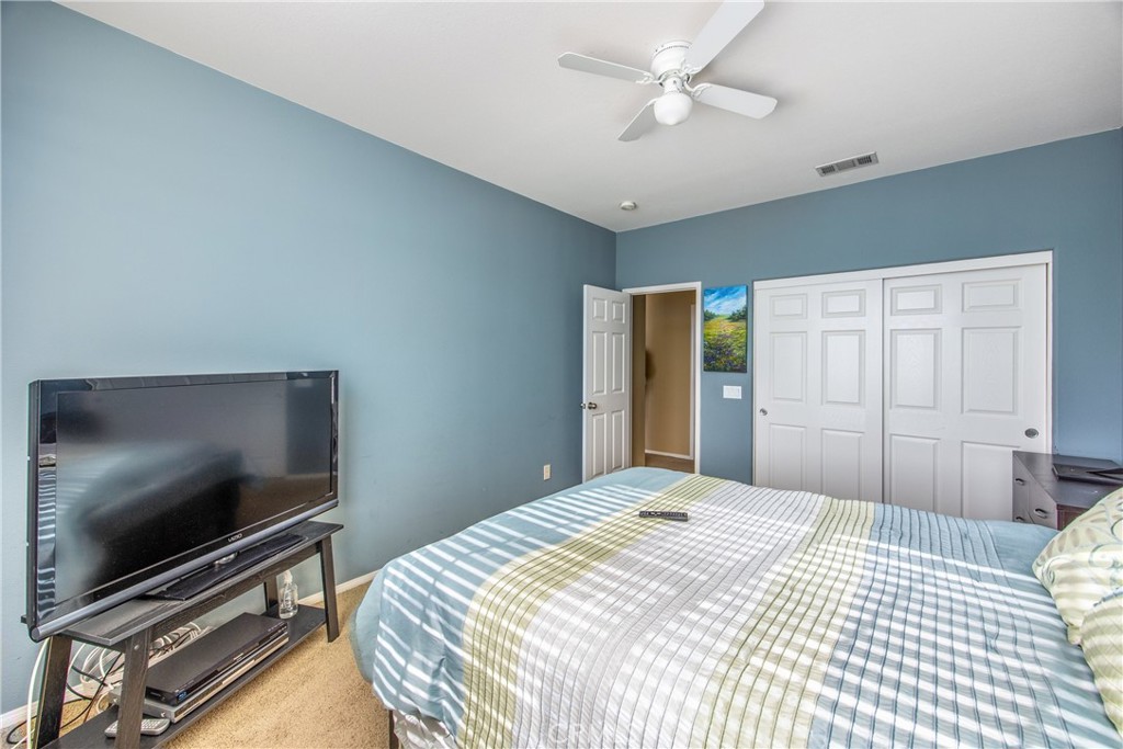 18936 Malkoha Street Perris, CA 92570 - Photo 41 of 70 a bedroom with a bed and a flat screen tv
