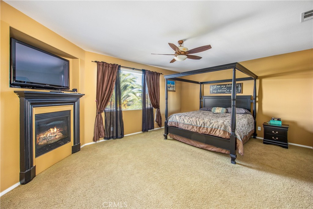 18936 Malkoha Street Perris, CA 92570 - Photo 42 of 70 a bedroom with a bed and a tv