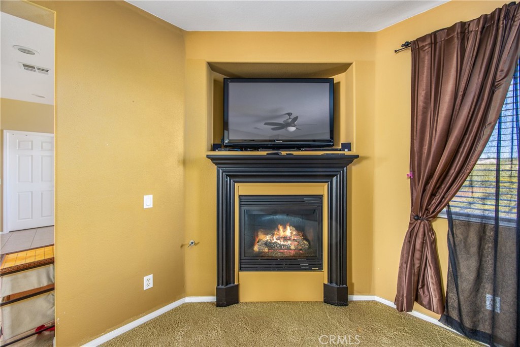 18936 Malkoha Street Perris, CA 92570 - Photo 43 of 70 a living room with a fireplace